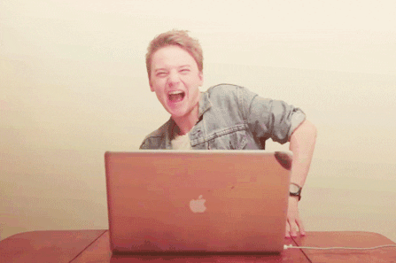 animated gif of woman dancing in front of laptop