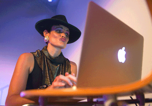 animated gif of woman dancing in front of laptop