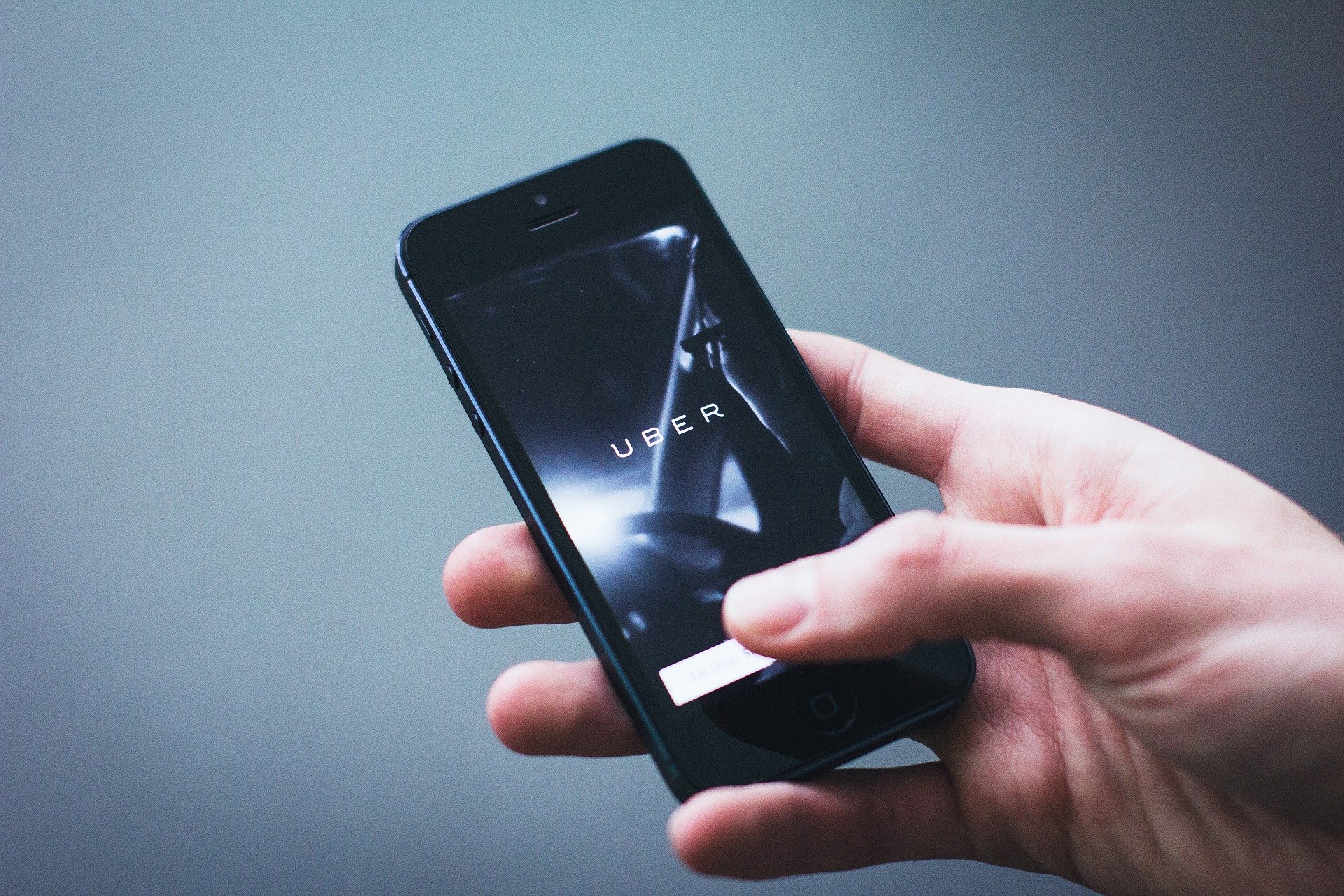 hand holding phone with Uber open